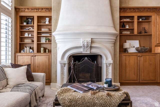 2726 E Wasatch Dr Unit 18, Salt Lake City, UT 84108 - living room with a fireplace with raised hearth, light colored carpet, and built in shelves