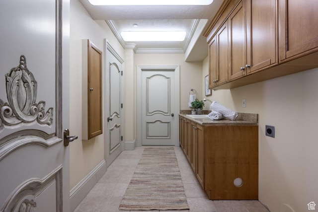 2726 E Wasatch Dr Unit 18, Salt Lake City, UT 84108 - laundry room with light tile patterned flooring, baseboards, ornamental molding, electric dryer hookup, and cabinet space