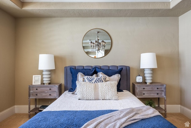 2726 E Wasatch Dr Unit 18, Salt Lake City, UT 84108 - carpeted bedroom featuring an inviting chandelier and baseboards
