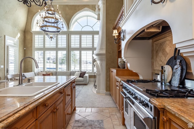 2726 E Wasatch Dr Unit 18, Salt Lake City, UT 84108 - kitchen with stone tile floors, a high ceiling, a sink, range with two ovens, and brown cabinets