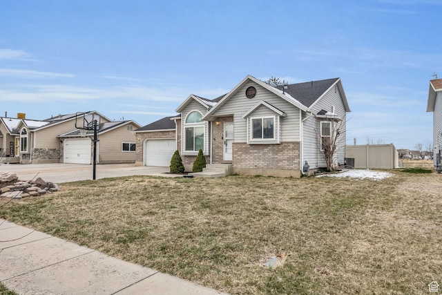 4933 S 3900 W, Roy, UT 84067 - view of front of house with an attached garage, brick siding, concrete driveway, and a front yard