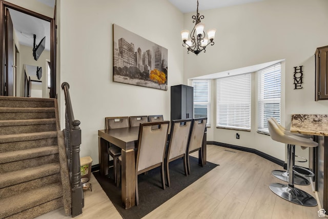 4933 S 3900 W, Roy, UT 84067 - dining space featuring visible vents, light wood-style flooring, a chandelier, baseboards, and stairs