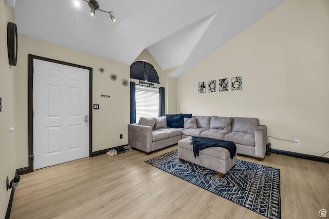 4933 S 3900 W, Roy, UT 84067 - living room featuring baseboards, lofted ceiling, and wood finished floors