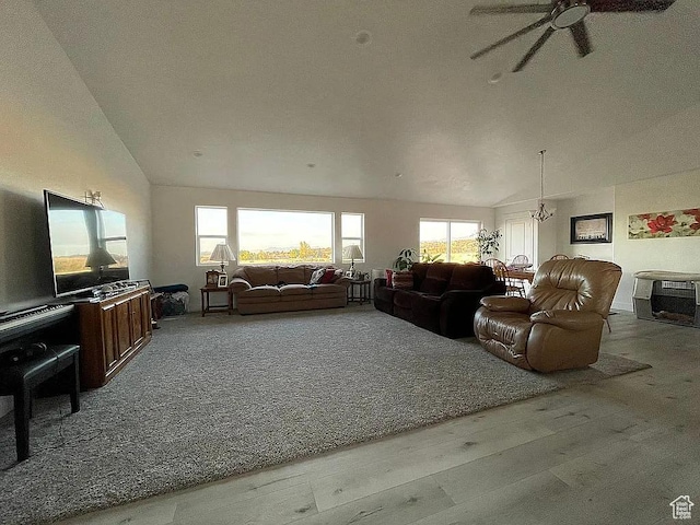 555 E 500 S, Fillmore, UT 84631 - living room featuring ceiling fan with notable chandelier, high vaulted ceiling, wood finished floors, and a wealth of natural light