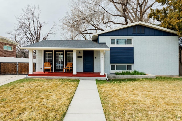 1305 N Valentine St, Salt Lake City, UT 84116 - split level home with covered porch, brick siding, and a front lawn