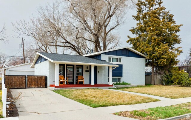 1305 N Valentine St, Salt Lake City, UT 84116 - split level home featuring a front yard, brick siding, a porch, and driveway