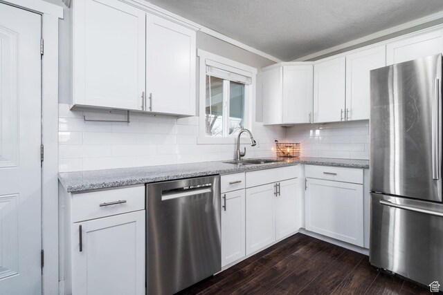 1305 N Valentine St, Salt Lake City, UT 84116 - kitchen with white cabinetry, tasteful backsplash, dark wood-type flooring, a sink, and appliances with stainless steel finishes
