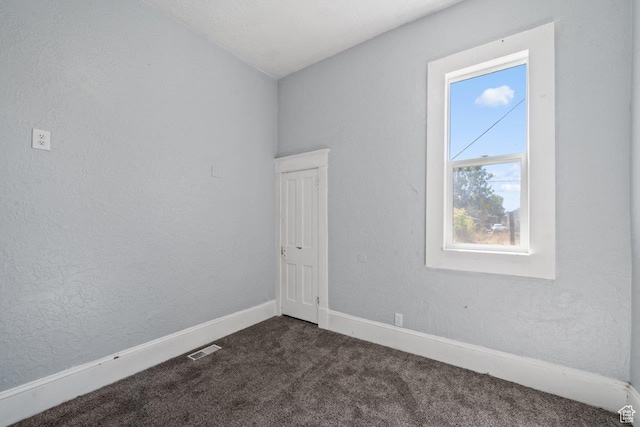 169 E 30th St S, Ogden, UT 84401 - empty room featuring a textured wall, baseboards, visible vents, and dark colored carpet