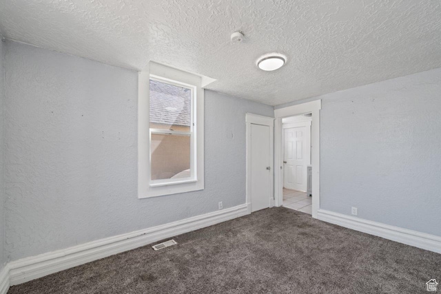 169 E 30th St S, Ogden, UT 84401 - empty room with visible vents, a textured wall, carpet flooring, and a textured ceiling