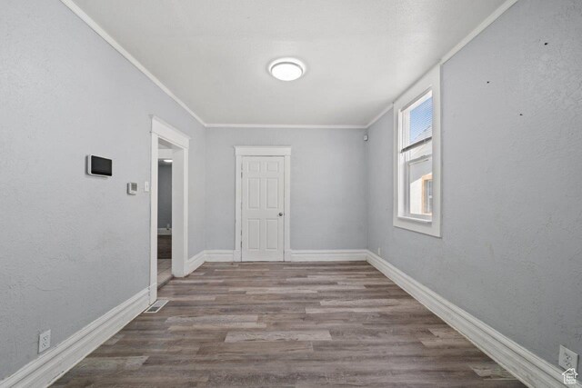 169 E 30th St S, Ogden, UT 84401 - spare room with a textured wall, ornamental molding, baseboards, and wood finished floors