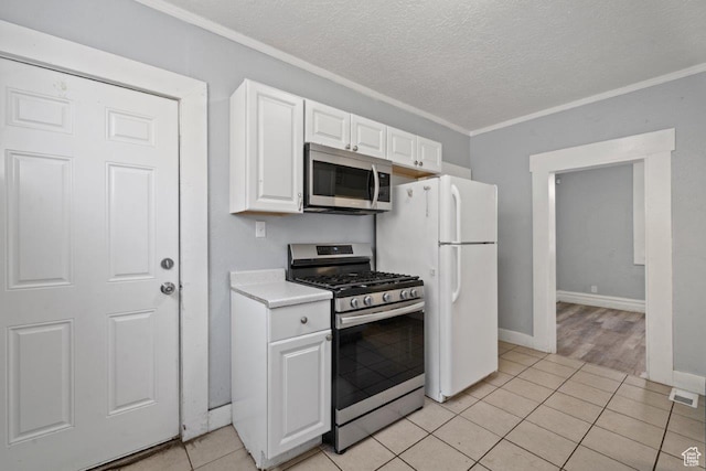 169 E 30th St S, Ogden, UT 84401 - kitchen featuring light countertops, appliances with stainless steel finishes, a textured ceiling, white cabinets, and ornamental molding