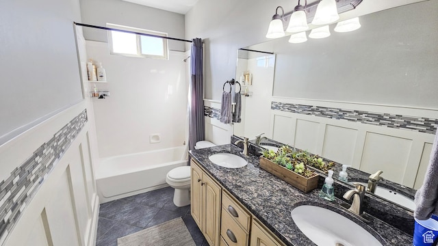 bathroom featuring shower / bath combo with shower curtain, toilet, a sink, and tile patterned flooring