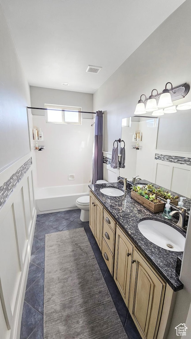 full bathroom featuring toilet, a sink, shower / bathtub combination with curtain, and visible vents