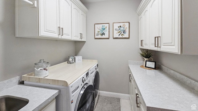 washroom with washer and clothes dryer, cabinet space, baseboards, and tile patterned floors
