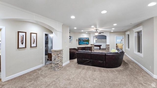 carpeted living room featuring arched walkways, ceiling fan, baseboards, and recessed lighting