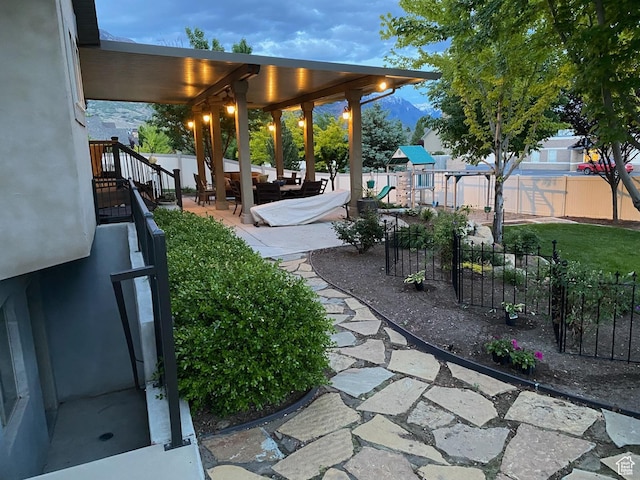 view of yard featuring an outdoor hangout area, a fenced backyard, a playground, and a patio area