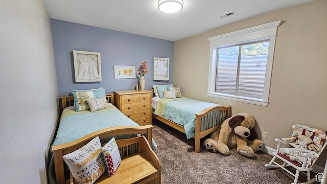 bedroom with baseboards, visible vents, and carpet floors