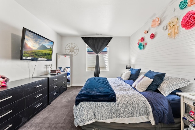 bedroom featuring dark carpet and visible vents