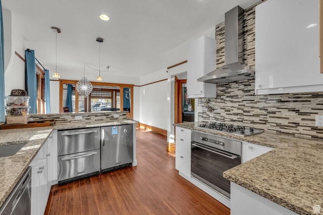 736 E 800 S, Salt Lake City, UT 84102 - kitchen featuring white cabinets, stainless steel appliances, wall chimney range hood, decorative light fixtures, and dark wood-type flooring