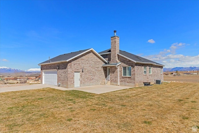 14480 N 8375 E, Spring City, UT 84662 - rear view of house with a chimney, central AC, brick siding, and a yard