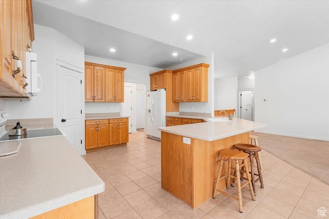 14480 N 8375 E, Spring City, UT 84662 - kitchen featuring a peninsula, white appliances, recessed lighting, a sink, and a breakfast bar area