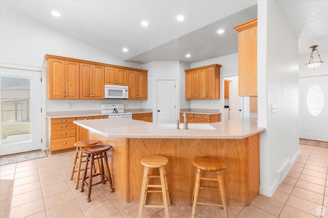 14480 N 8375 E, Spring City, UT 84662 - kitchen with light countertops, a sink, lofted ceiling, light tile patterned floors, and white appliances