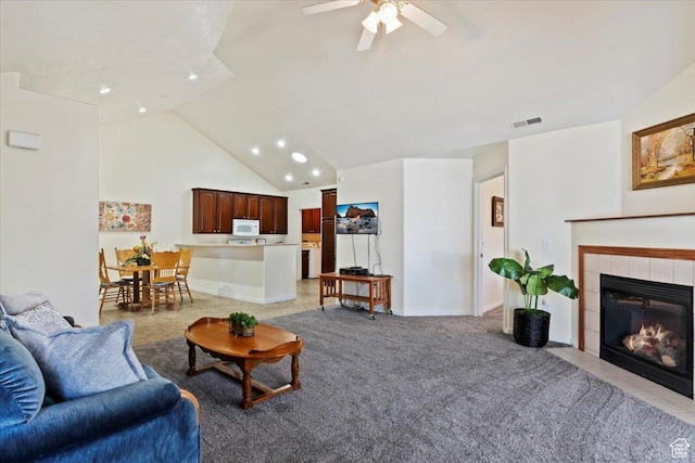 518 W 300 S Unit C, Springville, UT 84663 - living area featuring vaulted ceiling, light colored carpet, visible vents, a ceiling fan, and a tile fireplace