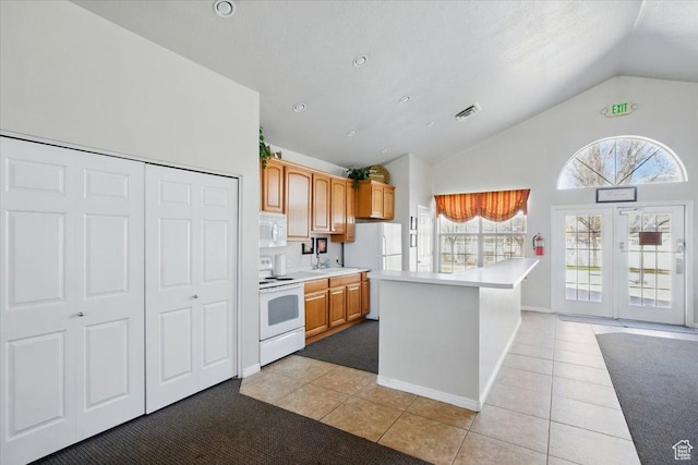 518 W 300 S Unit C, Springville, UT 84663 - kitchen featuring light tile patterned flooring, light countertops, baseboards, white appliances, and visible vents