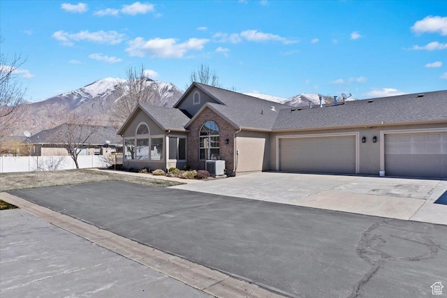 518 W 300 S Unit C, Springville, UT 84663 - view of front of house with central air condition unit, fence, a garage, concrete driveway, and a mountain view