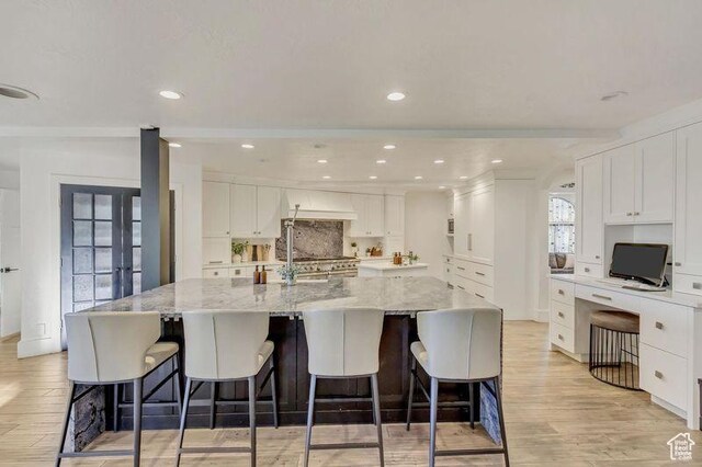 1448 E 155 S, Lindon, UT 84042 - kitchen featuring white cabinets, light wood-style flooring, and decorative backsplash