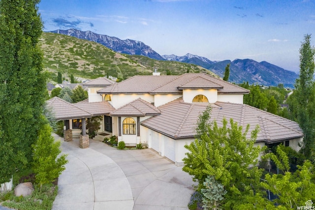 1448 E 155 S, Lindon, UT 84042 - mediterranean / spanish-style home with a mountain view, stucco siding, a tiled roof, and a garage