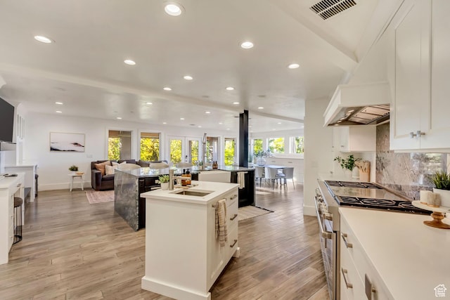 1448 E 155 S, Lindon, UT 84042 - kitchen with an island with sink, double oven range, open floor plan, visible vents, and light wood-style floors
