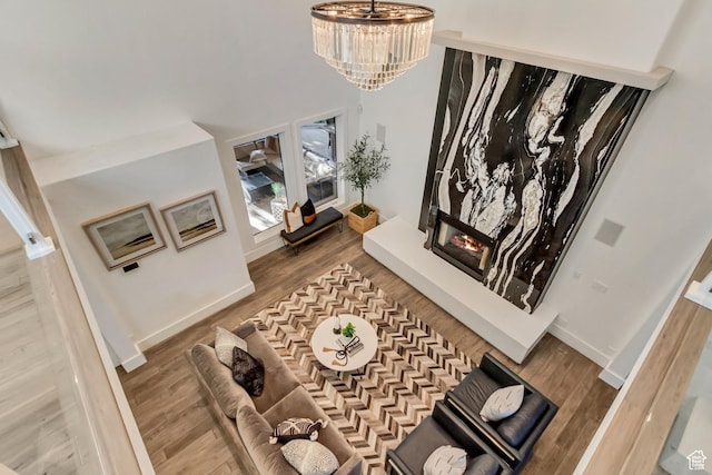 1448 E 155 S, Lindon, UT 84042 - living area with baseboards, wood finished floors, a glass covered fireplace, and a chandelier