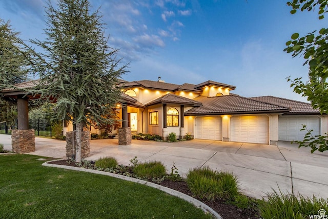 1448 E 155 S, Lindon, UT 84042 - view of front of property with stucco siding, an attached garage, a tiled roof, and curved driveway