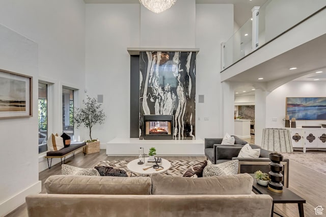 1448 E 155 S, Lindon, UT 84042 - living room featuring a high ceiling, a multi sided fireplace, and wood finished floors