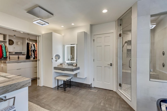 1448 E 155 S, Lindon, UT 84042 - bathroom with visible vents, recessed lighting, vanity, a stall shower, and a walk in closet