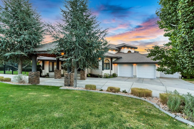 1448 E 155 S, Lindon, UT 84042 - view of front of house with driveway, an attached garage, a front yard, a tile roof, and stucco siding