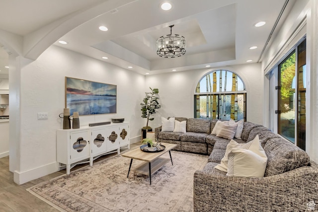 1448 E 155 S, Lindon, UT 84042 - living area with a tray ceiling, an inviting chandelier, baseboards, arched walkways, and light wood finished floors