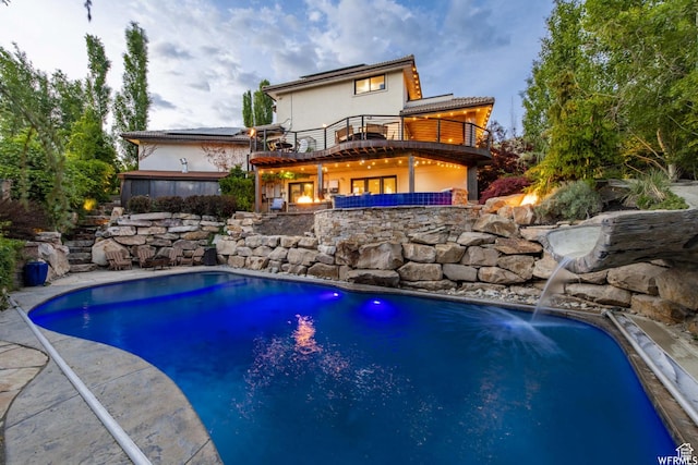 1448 E 155 S, Lindon, UT 84042 - back of property with stucco siding, an outdoor pool, a patio area, and a balcony