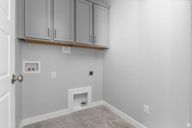 laundry room with baseboards, washer hookup, hookup for an electric dryer, and cabinet space
