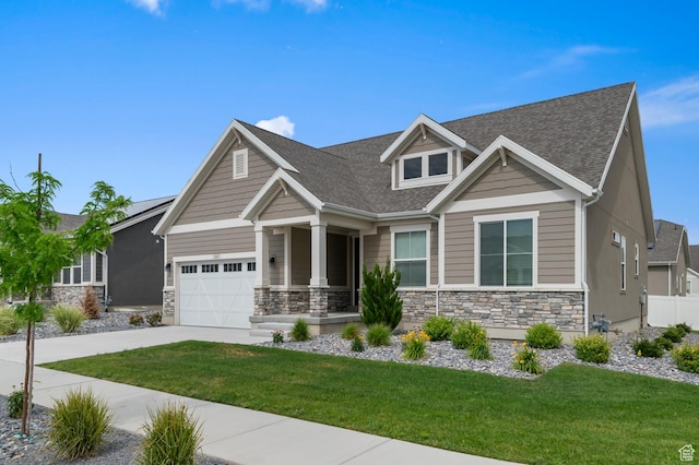 6606 N Furner Rdg, Eagle Mountain, UT 84005 - craftsman house with driveway, stone siding, a front lawn, and a garage