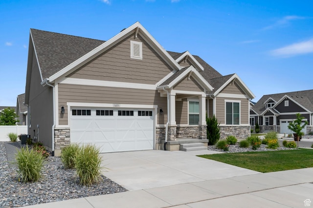 6606 N Furner Rdg, Eagle Mountain, UT 84005 - craftsman house featuring an attached garage, stone siding, concrete driveway, and roof with shingles