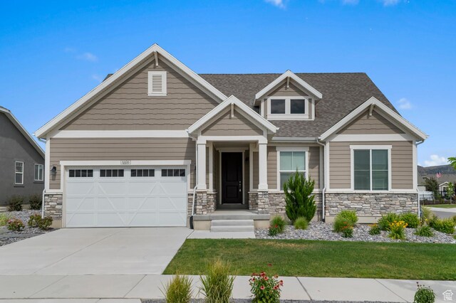 6606 N Furner Rdg, Eagle Mountain, UT 84005 - craftsman inspired home featuring stone siding, driveway, roof with shingles, and a front lawn