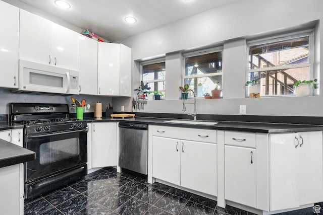 427 E 1st Ave, Salt Lake City, UT 84103 - kitchen with black gas range, a sink, dark countertops, dishwasher, and white microwave