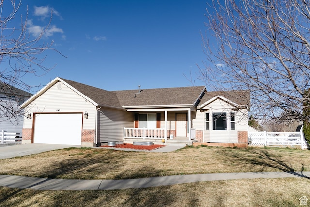 view of front facade with concrete driveway, fence, an attached garage, a front lawn, and a porch