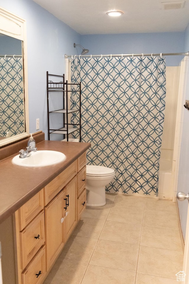 full bath featuring toilet, vanity, tile patterned flooring, and visible vents