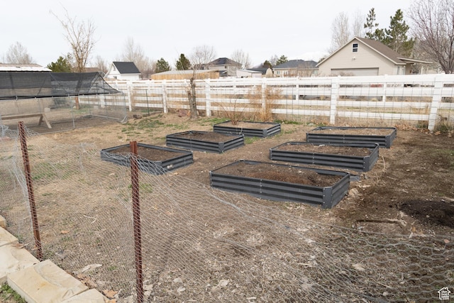 view of yard with fence and a garden