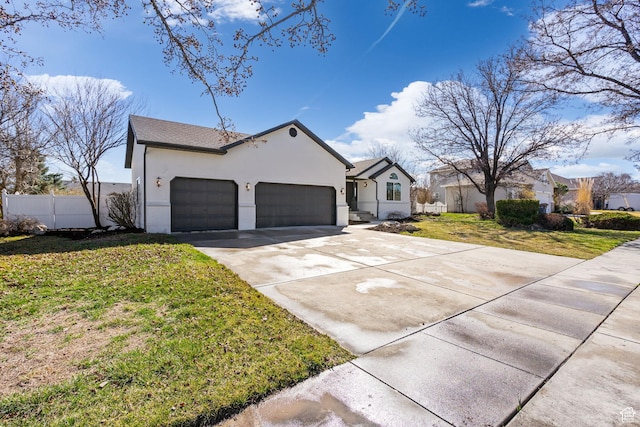 view of front of property featuring fence, a garage, concrete driveway, a front yard, and stucco siding