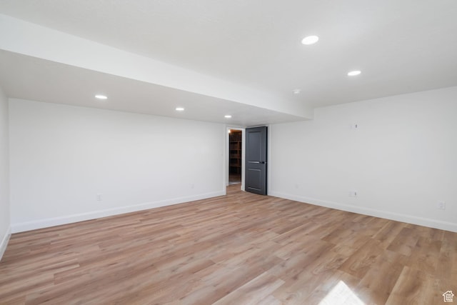 empty room featuring baseboards, recessed lighting, and light wood finished floors