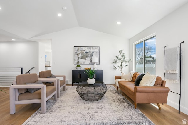 living room featuring recessed lighting, baseboards, lofted ceiling, and wood finished floors